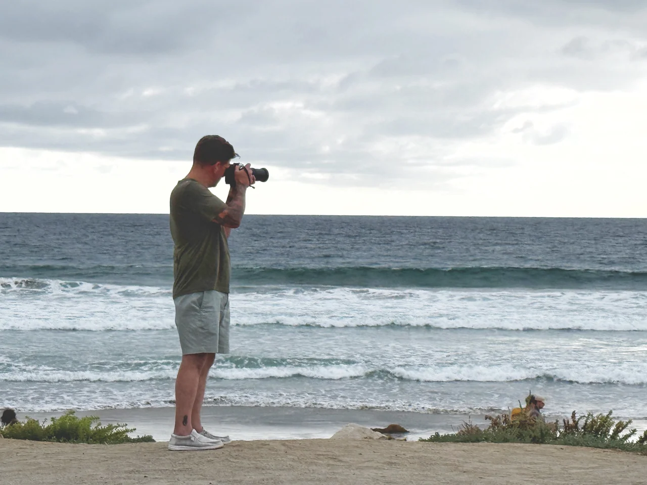 Josh Walker photographs the ocean from a coastal path.