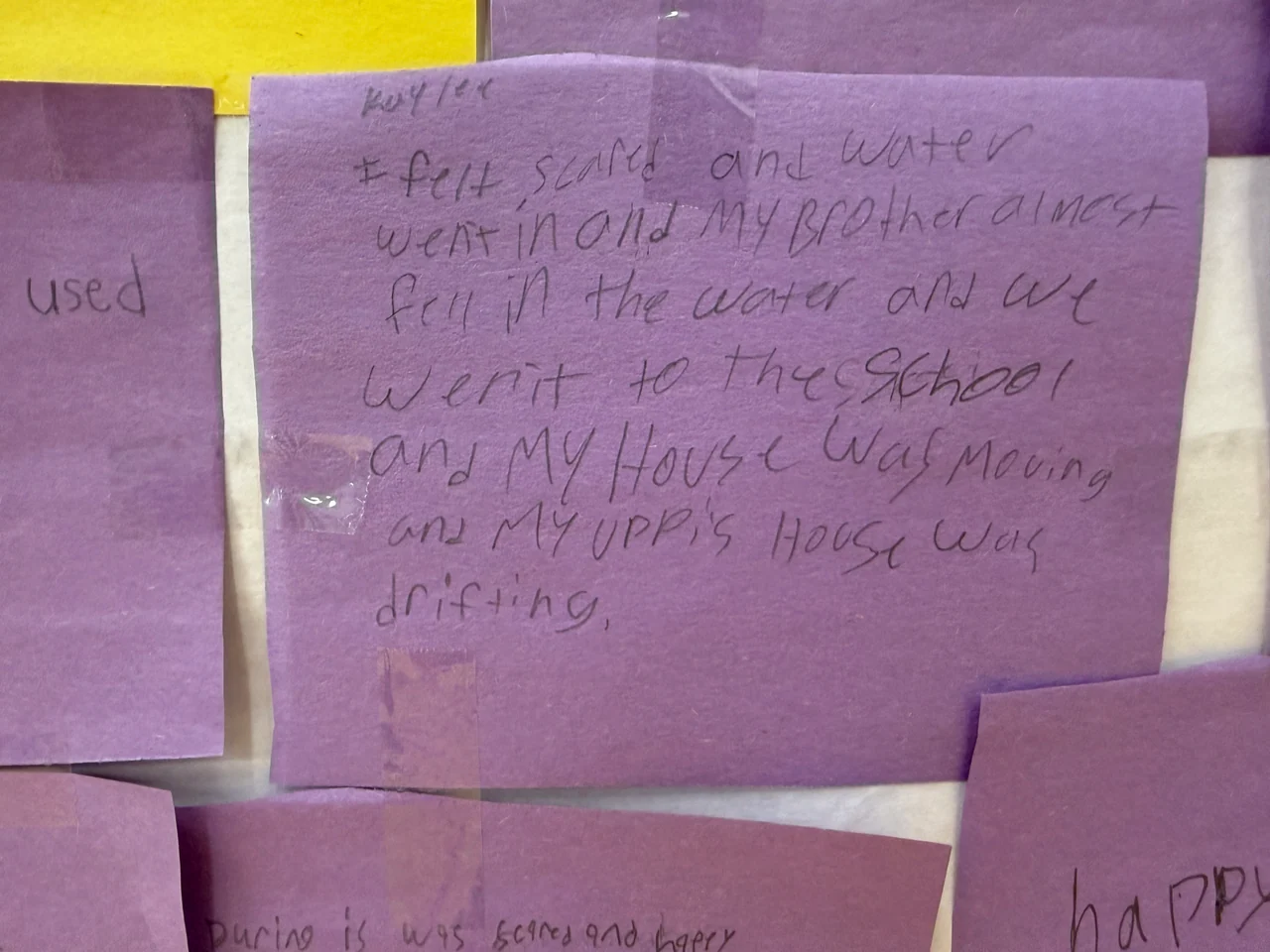 A handwritten account on a purple note describes deep water and loss during flooding.